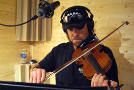 Joe Caverlee, studio musician in Nashville, Tennessee, playing fiddle at Panda Productions of Nashville recording studio